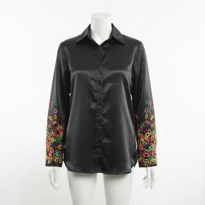 Long sleeved shirt with playful abstract pattern on sleeve.