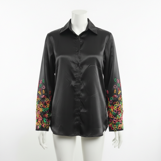 Long sleeved shirt with playful abstract pattern on sleeve.